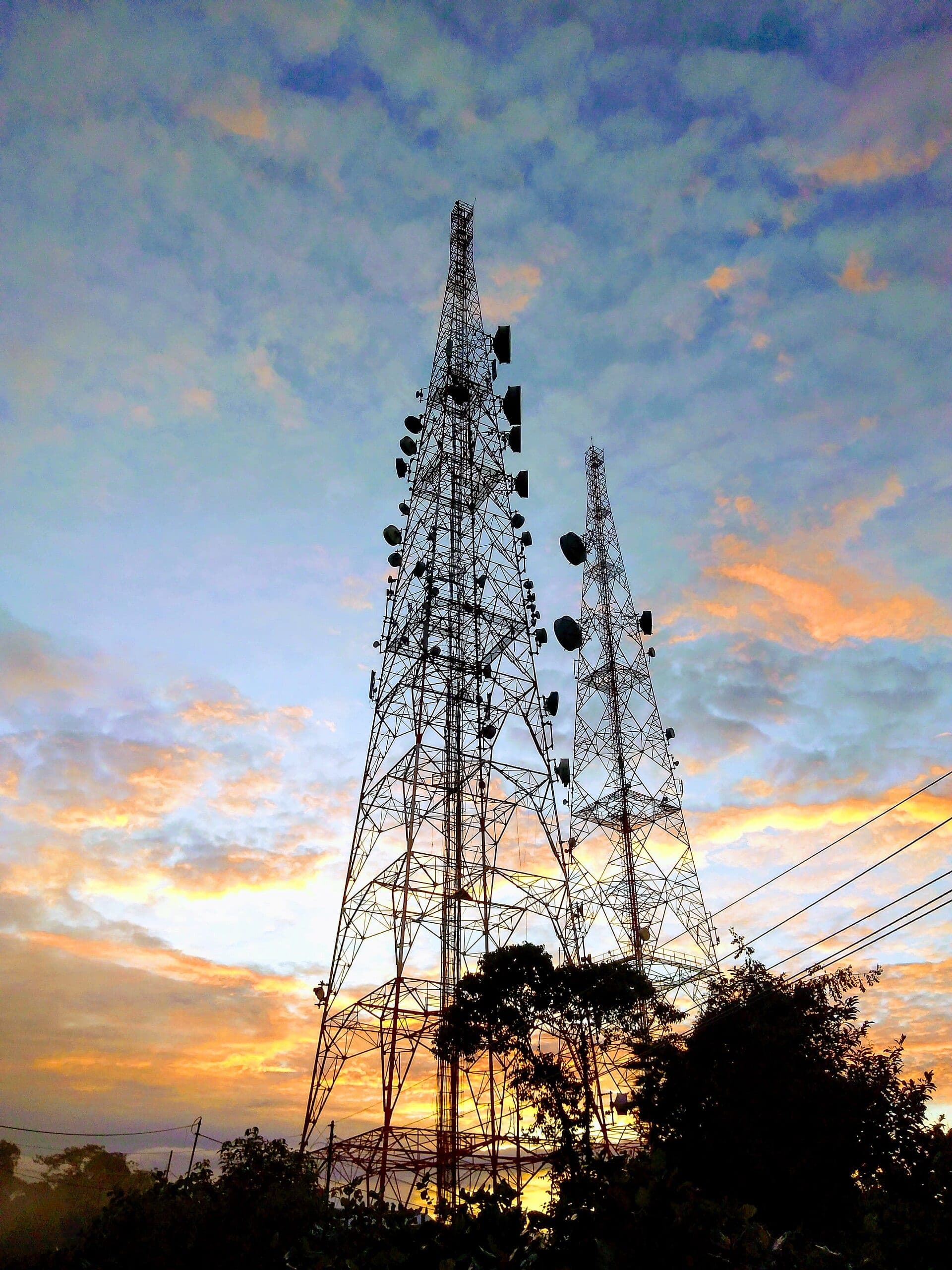 Telecommunications towers against an evening sky
