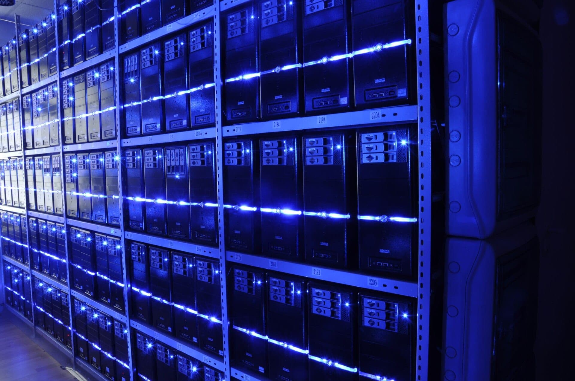 Rows of illuminated server racks inside a mission-critical data center