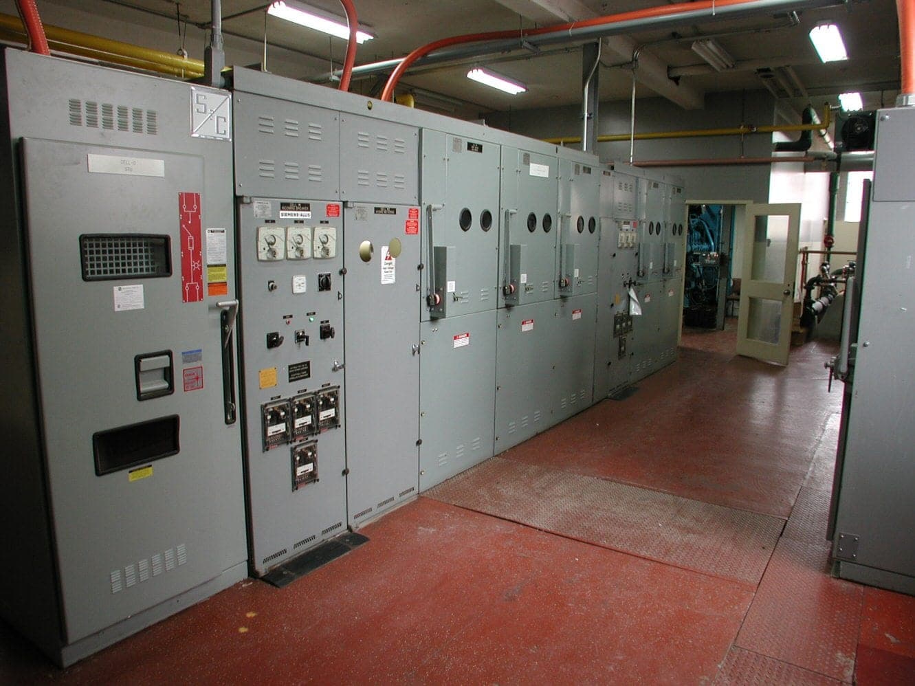 Row of low-voltage electrical switchgear panels in a distribution room